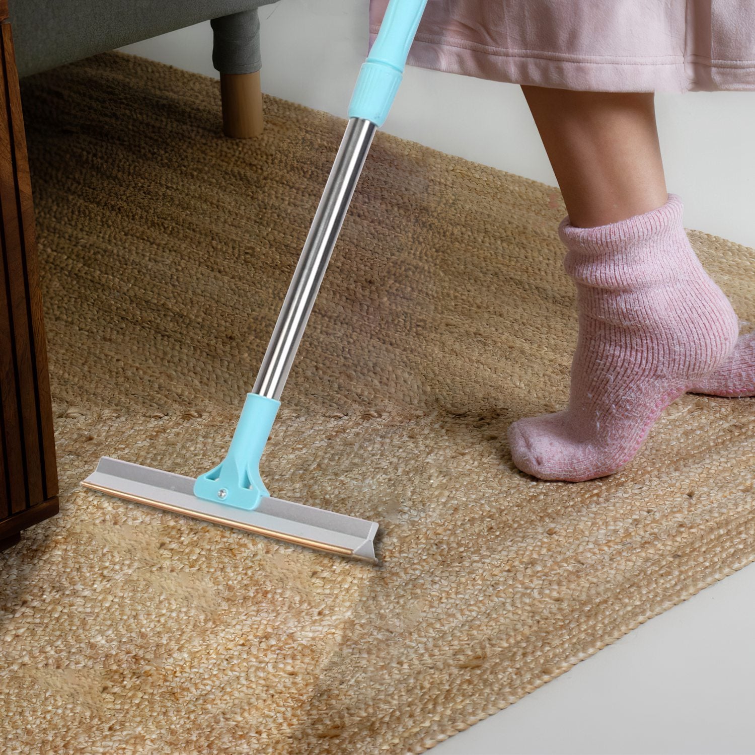 Using the telescopic rake on a rug while standing