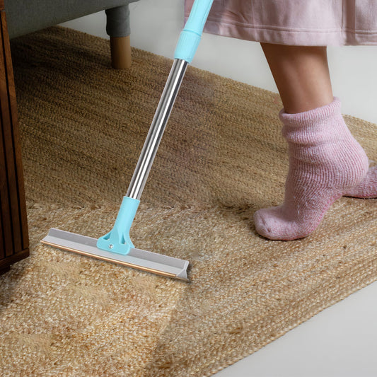 Using the telescopic rake on a rug while standing